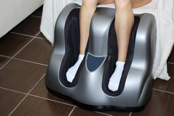 A person using a modern leg massager with foot and calf compartments, designed to provide relaxation and improve circulation.